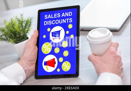 Tablet screen displaying a sales and discounts concept Stock Photo - Alamy