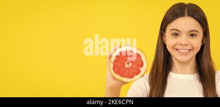 presenting cosmetic product for teen. kid use shower gel. shampooing long hair in salon. Child girl portrait with grapefruit orange, horizontal poster Stock Photo