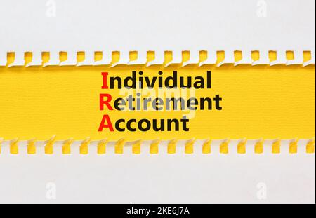 IRA individual retirement account symbol. Concept words IRA individual retirement account on yellow paper on beautiful white background. Business IRA Stock Photo