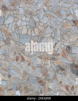 Front view of stone wall made of weathered and multi-colored stone slates. Abstract high resolution full frame textured background. Stock Photo