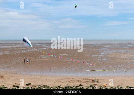 Flying kites on Leysdown beach, Leysdown on Sea, Isle of Sheppey, Kent, England, UK Stock Photo