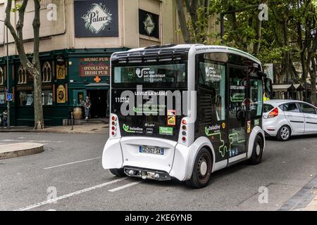 An electric bus traversing the city centre of Avignon, France Stock Photo