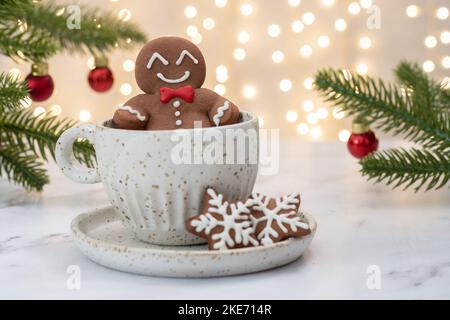 Gingerbread cookie man in a hot cup of cappuccino Stock Photo