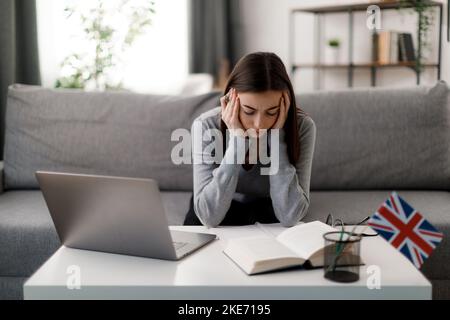 Tired student using laptop Stock Photo