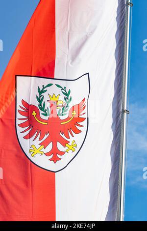 Red and white colored Flag with shield bearing a red eagle; Flag of South Tyrol (Südtirol, Alto Adige) officially named Autonomous Province of Bolzano Stock Photo