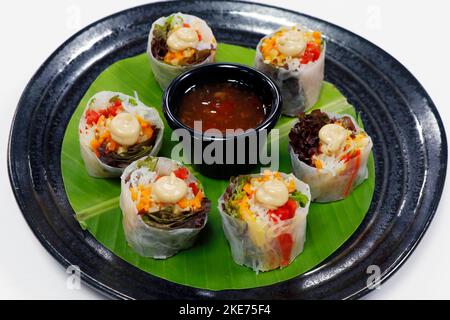vietnamese style vegetable spring rolls with lettuce, chili, carrot and bell peppers Stock Photo