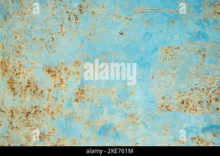 Old weathered rusty tin metal sheet surface closeup as grunge blue background Stock Photo