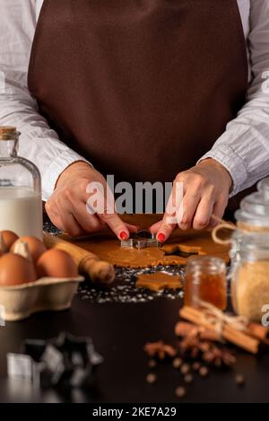 Food photography of  ingredients for gingerbread,  dough, woman, cookies, biscuits, cooking, preparation, cinnamon, anise Stock Photo