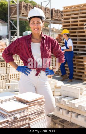 Asian female worker posing at construction store Stock Photo