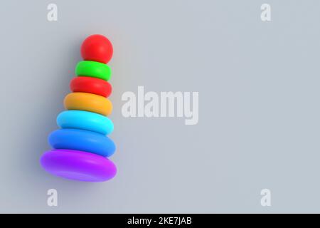 Toy pyramid tower on gray background. Children education. Educational games. Preschool development. Copy space. Top view. 3d render Stock Photo