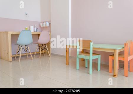Modern Occupational Therapy Classroom. Nice Colored Wooden Furniture Sets with Tables and Chairs. Interior Design and Stylish Decoration. Stock Photo