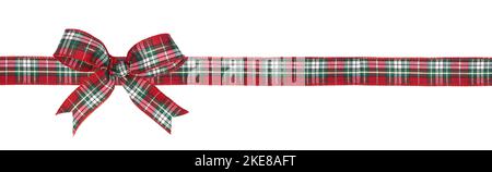 Red, green and white plaid Christmas gift bow and ribbon. Long border isolated on a white background. Stock Photo