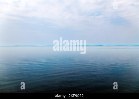 Foggy; misty view of Cook Inlet from Kenai Peninsula; Lake Clark National Park & Preserve beyond; Alaska; USA Stock Photo