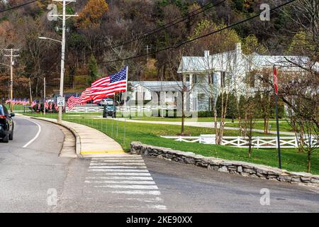 American flags inline on the road, commemorating veterans‘s day, At the distillery main entrance in Lynchburg Tennessee USA. Stock Photo