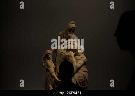 Person in darkness observing the Bandini Pietà Stock Photo