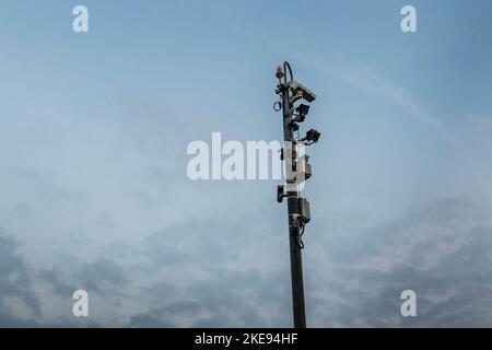 Large post with multiple cameras and listening devices, CCTV Stock Photo