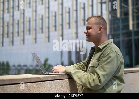 Caucasian man communicates in sign language via video link on laptop.  Stock Photo