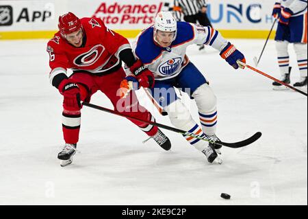 Raleigh, North Carolina, USA. 10th Nov, 2022. Carolina Hurricanes defenseman Brady Skjei (76) and Edmonton Oilers left wing Zach Hyman (18) battle for the puck in the first period during a game between the Edmonton Oilers and the Carolina Hurricanes at PNC Arena in Raleigh, NC, on November 10, 2022. (Credit Image: © Spencer Lee/ZUMA Press Wire) Stock Photo