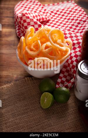 Chicharrones de Harina. Also known as duros, duritos, Mexican wagon wheels or pinwheels, they are a very popular snack made from flour, commonly accom Stock Photo