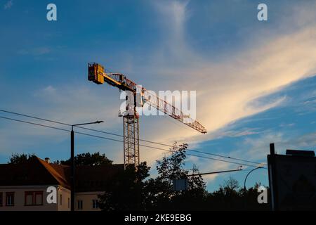Yellow construction crane on blue sky Stock Photo