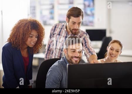 They produce the most dynamic work together. a group of colleagues working together in an office. Stock Photo