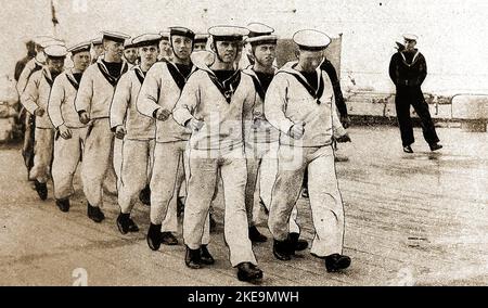 Circa 1930 A group of sailors aboard HMS Marlborough undertaking exercise on deck. She was  an Iron Duke-class battleship of the Royal Navy, named in honour of John Churchill, 1st Duke of Marlborough. - Ordered 1911 - Built at  Devonport Dockyard - Keel laid down  25 January 1912 - Launched 24 October 1912 -  Commissioned -- June 1914   ---  The vessel was  scheduled to be removed from service in 1931 but instead was used for target practice  until scrapped in 1932. Stock Photo