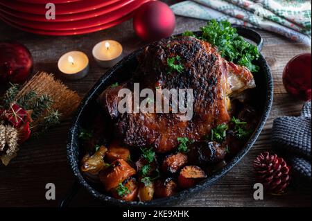 Christmas roast  on wooden table with tea lights. Roasted turkey shanks Stock Photo