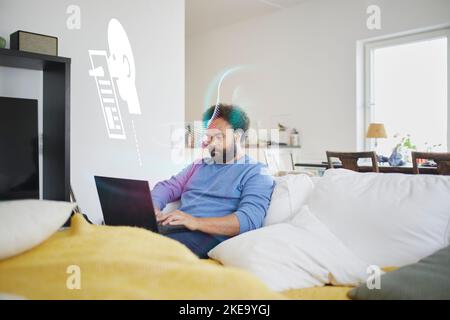 Man reading fake news on laptop Stock Photo