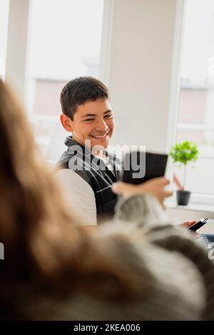 Girl showing brother smart phone Stock Photo