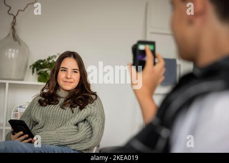 Boy showing sister smart phone Stock Photo