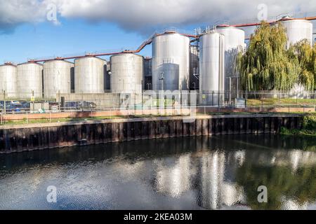 Storage vats at the rear of Carlsberg brewery taken from a public footpath, Northampton, England, UK. Stock Photo