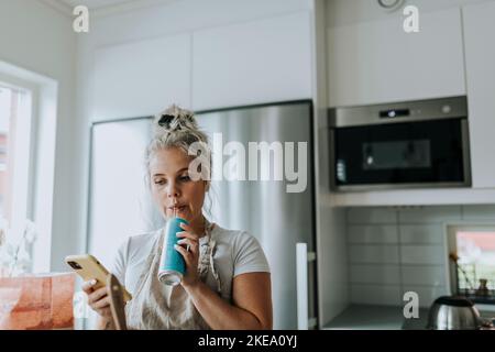 Smiling woman in kitchen Stock Photo