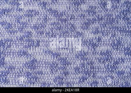 Close up background of knitted wool fabric made of viscose yarn. Mix of blue and white color, melange wool knitwear texture. Abstract knitted jersey b Stock Photo