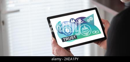 Trust concept shown on a tablet held by a man Stock Photo