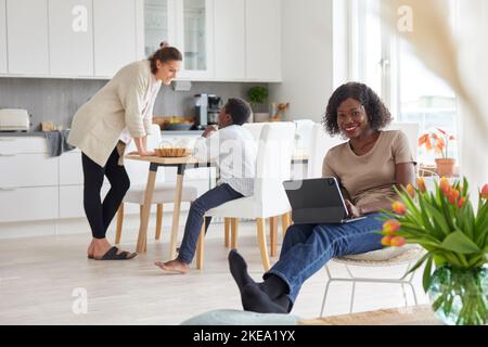 Family working and having meal at home Stock Photo