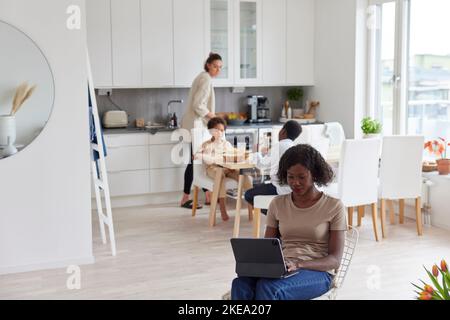 Family working and having meal at home Stock Photo