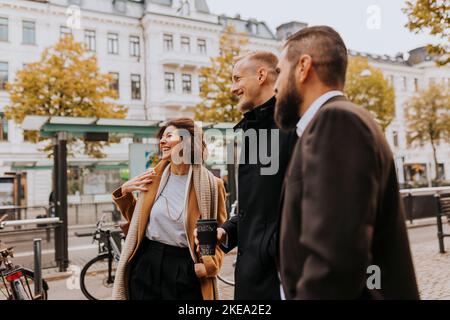 Smiling business people standing together Stock Photo