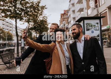Smiling business people taking selfie Stock Photo