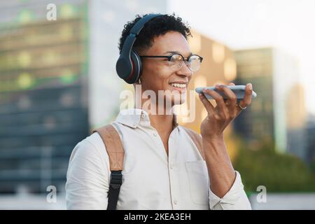 Man, 5g phone and voice note in the city traveling to university lesson and using his mobile. College student, travel and cellphone call using Stock Photo