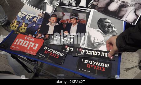 JERUSALEM, ISRAEL - NOVEMBER 10: Far right-wing activists take stickers which read 'We want revenge', 'Leftists are traitors' and 'Death to terrorists' during a ceremony honoring late Jewish extremist leader Rabbi Meir Kahane, founder of the Kach party on November 10, 2022 in Jerusalem, Israel. Meir Kahane's party Kach, was barred from running for the Israeli parliament as the result of the extremist views the party promoted against Arabs. The United States, also outlawed the Kach movement and categorized it as a terrorist organization. Credit: Eddie Gerald/Alamy Live News Stock Photo