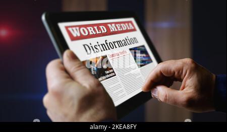 Disinformation fake news, manipulation and propaganda daily newspaper reading on mobile tablet computer screen. Man touch screen with headlines news a Stock Photo