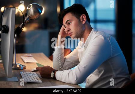 Businessman, stress or bored on computer in night office for cyber security website, digital marketing web design or programming code. Anxiety, tired Stock Photo