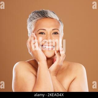 Beauty, skincare and senior woman touching soft skin after cosmetics, makeup and dermatology for healthy, glow and clear face. Portrait and smile of Stock Photo