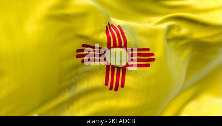 Flag of New Mexico state waving in the wind. New Mexico is a federated state in the southwestern United States. Fabric textured background. Selective Stock Photo