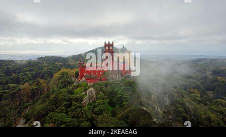 Aerial drone view of Park and National Palace of Pena in Sintra, Portugal during a foggy day. Unesco. Historic visits. Sightseeing. Fairytale. Stock Photo