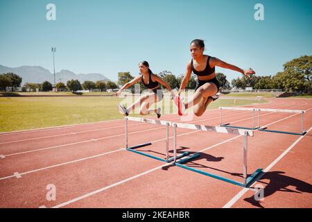 Sport, jump and women runner doing hurdles on stadium track, athlete running race and fitness training outdoor. Practice, workout and sports, speed Stock Photo