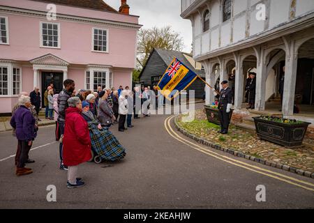 Thaxted Essex England  Armistice Day 11 November 2022 A small town remembers the fallen of all wars. At the going down of the sun, we shall remember them…Armistice Day in Thaxted, Essex, England when at 11 o'clock on the 11th day of the 11th month (11th of November) residents of Thaxted and thousands of other small and large communities up and down the British Isles and further abroad remember those who fell in all conflicts arond the world since the end of the First World War. Seen here: Mick Mizon formerly of the Royal Gree Jackets, Standard Bearer for the local Royal British Legion, lowers Stock Photo