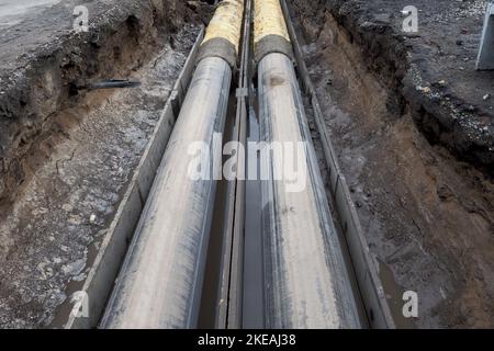 Repair of urban communications. Replacement of water pipes, repair and reconstruction of heating mains. Hot and cold water pipe laid in trench.. Stock Photo