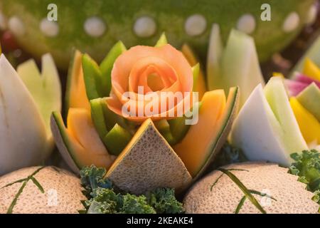 Cantelope is cut into fanciful flower on buffet table. Stock Photo