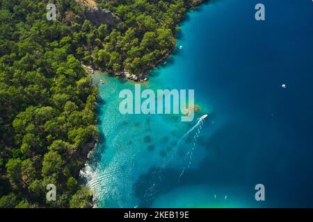 Aerial view of blue sea and boat sailing along the mediterranean coast. Landscape of turkish riviera nature Stock Photo